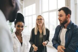 Young collaborating people in business office