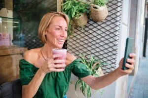 young woman drinking a healthy drink for social media